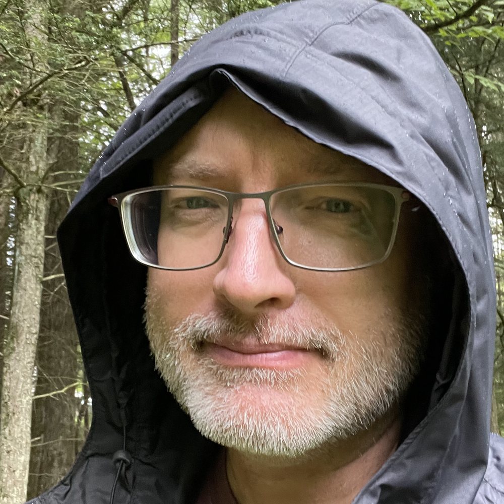Jeff Hobbs, hood up, in the woods